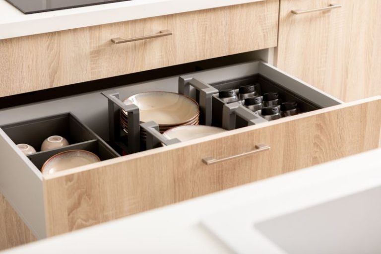 Kitchen Organizing - an open drawer in a kitchen filled with dishes