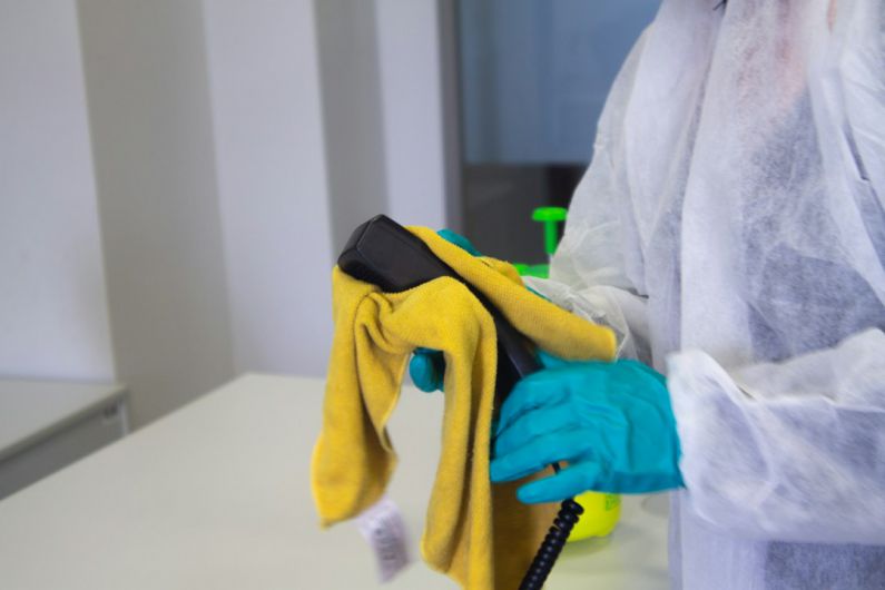 Deep Cleaning - person in white robe holding black and yellow umbrella